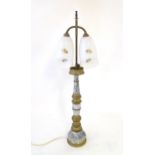 A mid 20thC table lamp, the column consisting of alternating brass and onyx sections supporting a