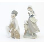 Two Lladro figures comprising Girl with Doves model no. 4915 and Boy with Dog model no. 4522.