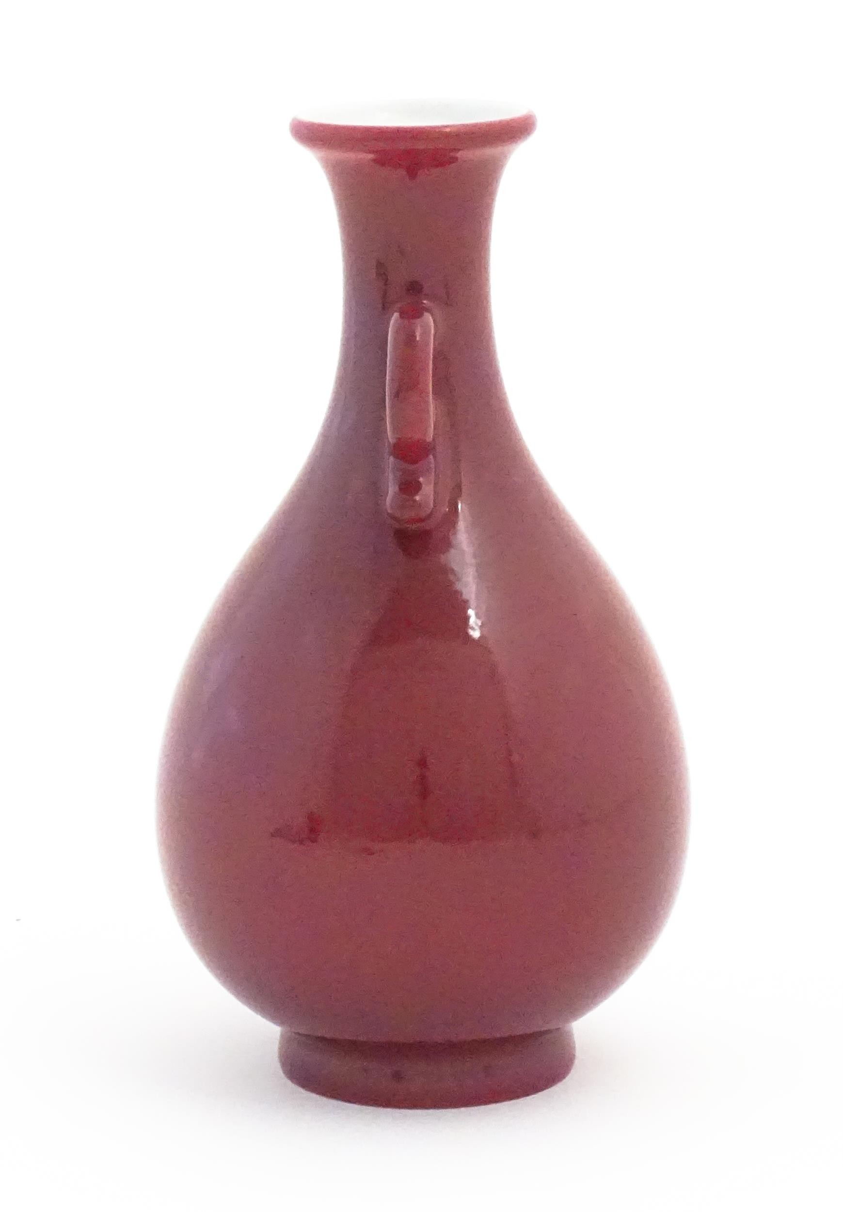 A Chinese vase with shaped twin handles and a red / pink ground. Character marks under. Approx. 6 - Image 3 of 7