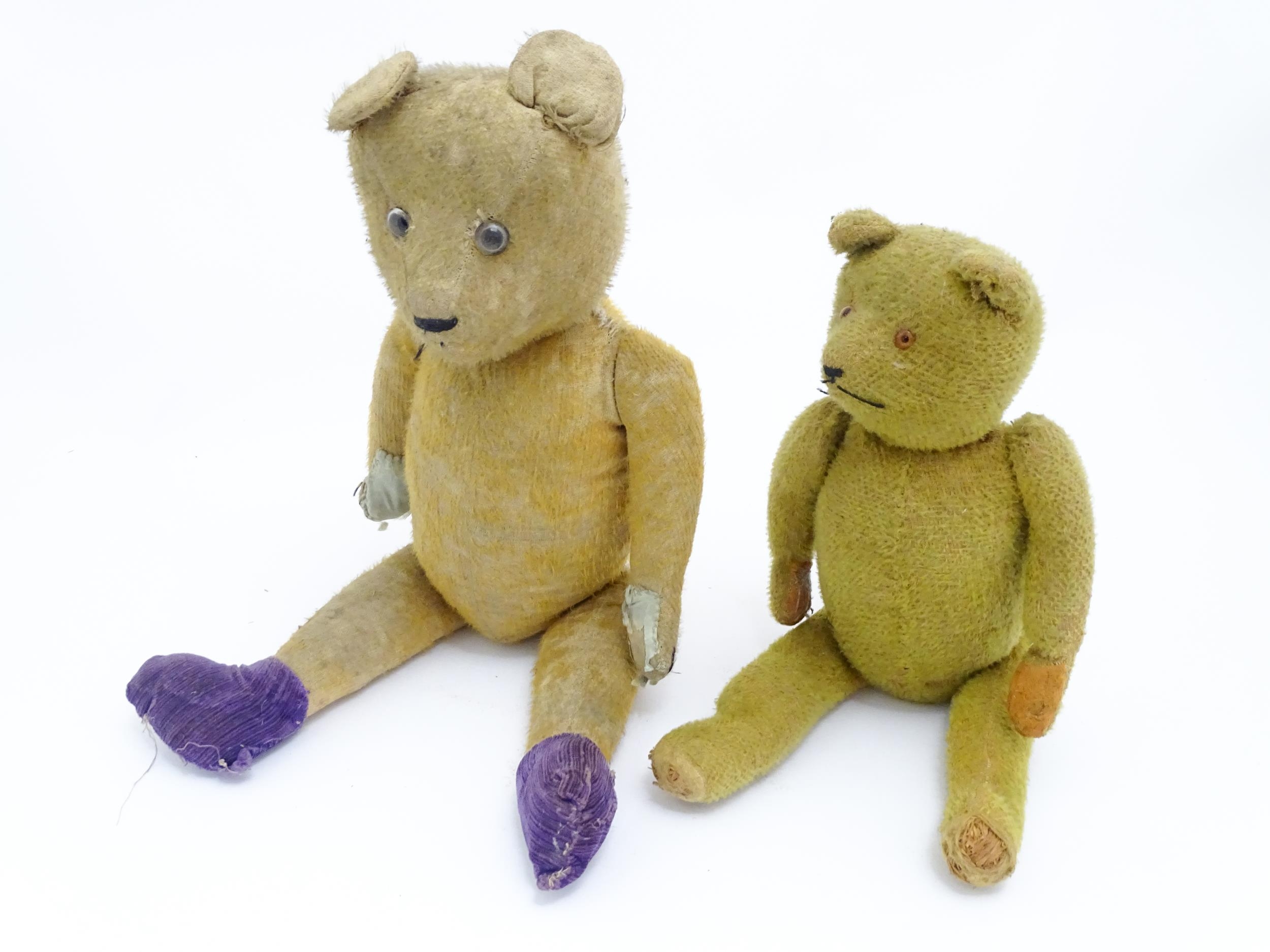Toys: An early 20thC straw filled teddy bear with glass eyes, stitched nose and mouth and growler