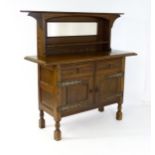 A late 19thC oak Arts and Crafts sideboard, attributed to Liberty & Co. Having a flat cornice