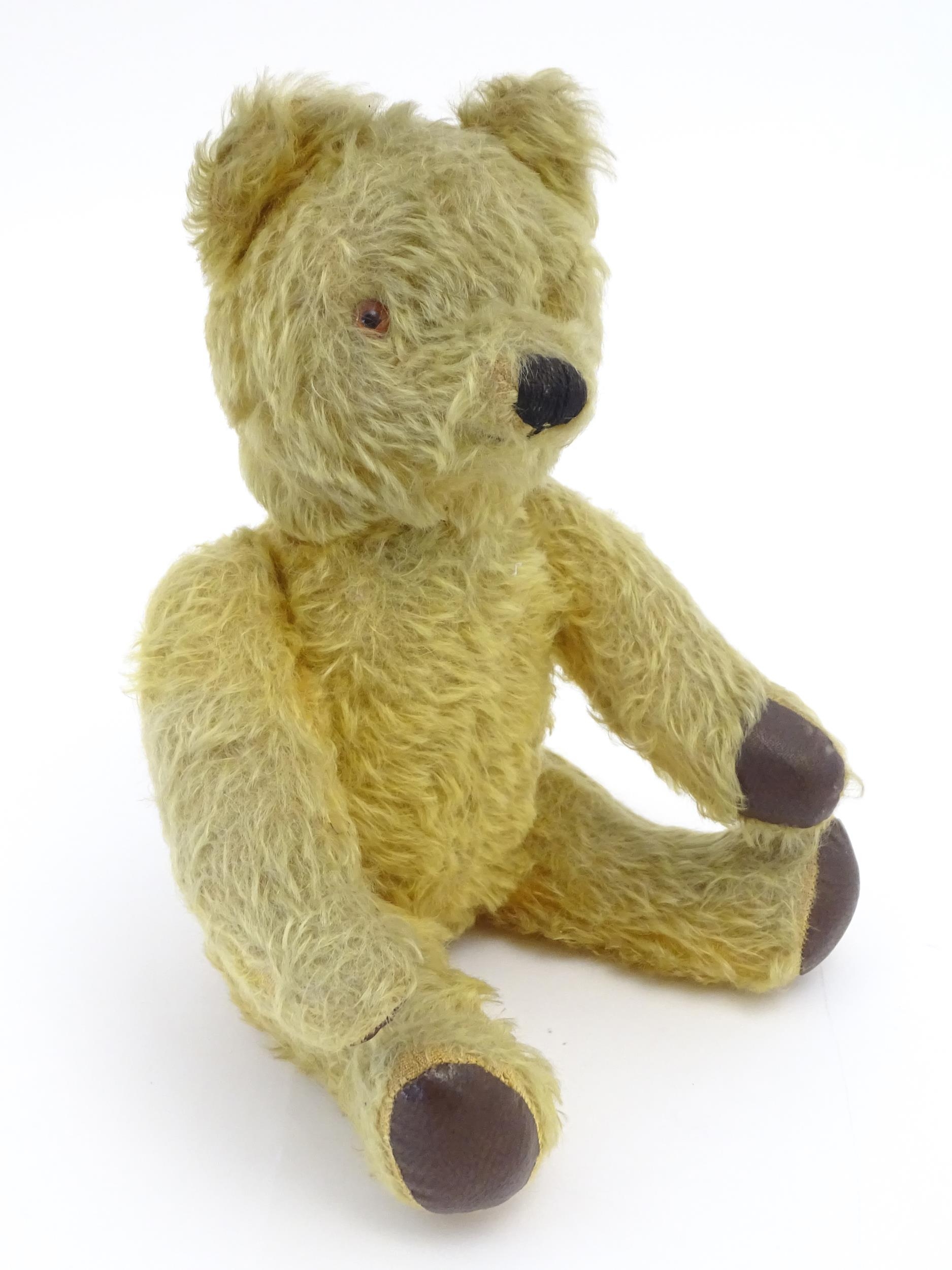 Toy: A 20thC mohair teddy bear with stitched nose and mouth, pad paws and articulated limbs, a