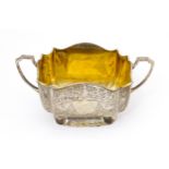 A silver sugar basin with twin handles, engraved foliate detail and gilded interior. Hallmarked