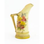 A Royal Worcester blush ivory jug, the body decorated with floral sprays, the handle modelled as
