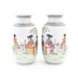 A pair of Japanese vases decorated with female figures in a garden landscape, three ladies seated