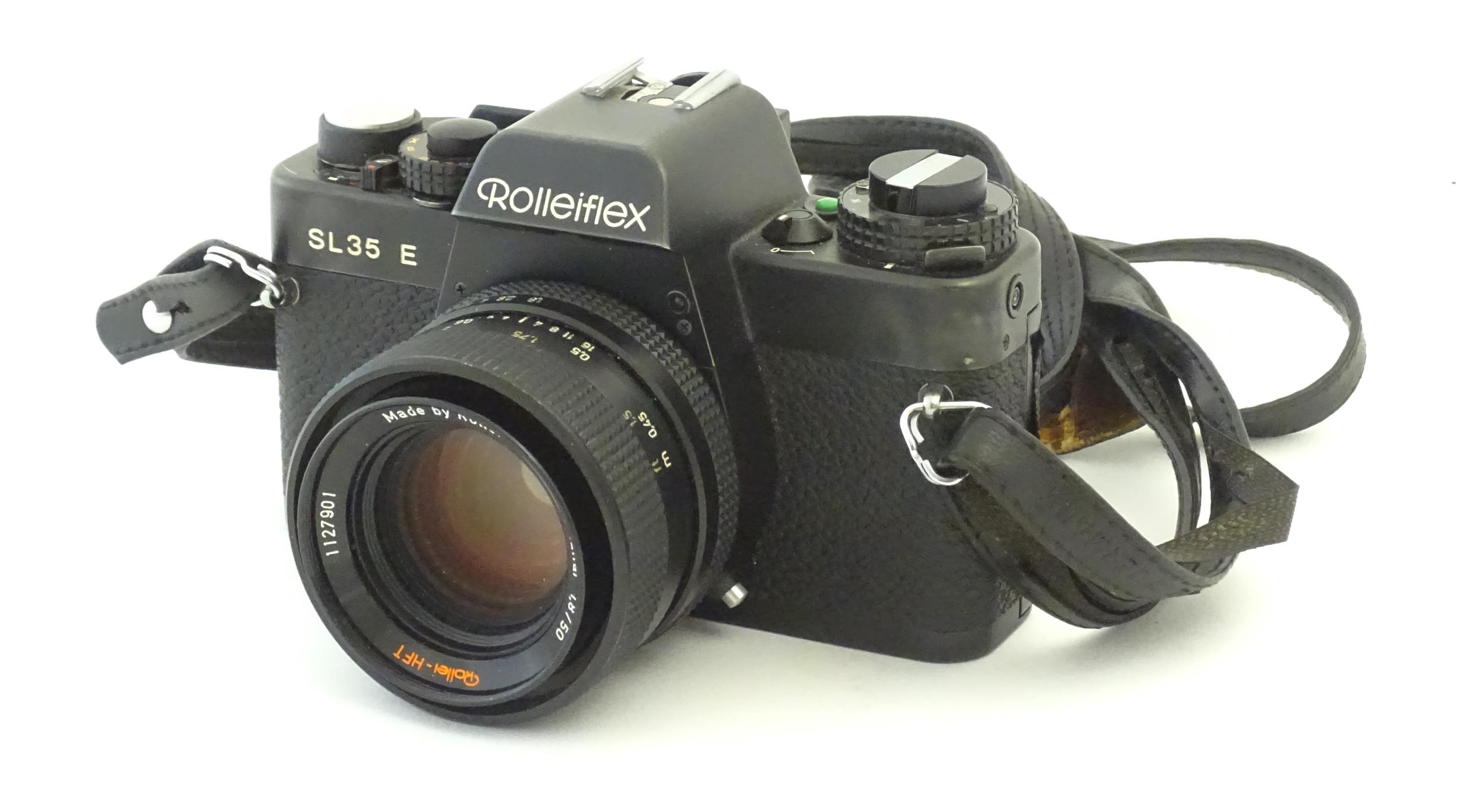 A Rolleiflex SL35 E 35mm film camera, c1970s, cased with lens cap. 5 1/8" Please Note - we do not