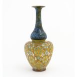 A Doulton Lambeth ovoid vase with mottled blue glaze to neck and lace work floral detail to body.