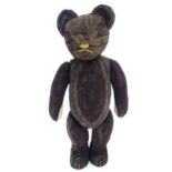 Toy: A 20thC straw filled teddy bear with stitched nose, mouth and claws, pad paws and articulated