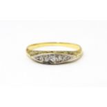 An 18ct gold ring set with 5 graduated diamonds. Ring size approx. M Please Note - we do not make