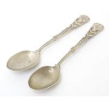 A pair of silver spoons decorated with golf clubs, golf balls, etc. hallmarked Sheffield 1931, maker