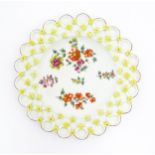 A Derby spectacle plate with pierced border moulded with flowers, with painted floral sprays to