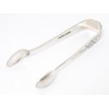 Silver sugar tongs with engraved decoration, hallmarked Sheffield 1913 W S Savage & Co. Approx. 4"