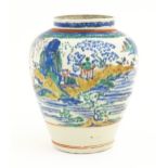 A Japanese Kakiemon style jar / vase of ovoid form decorated with a lake scene with small