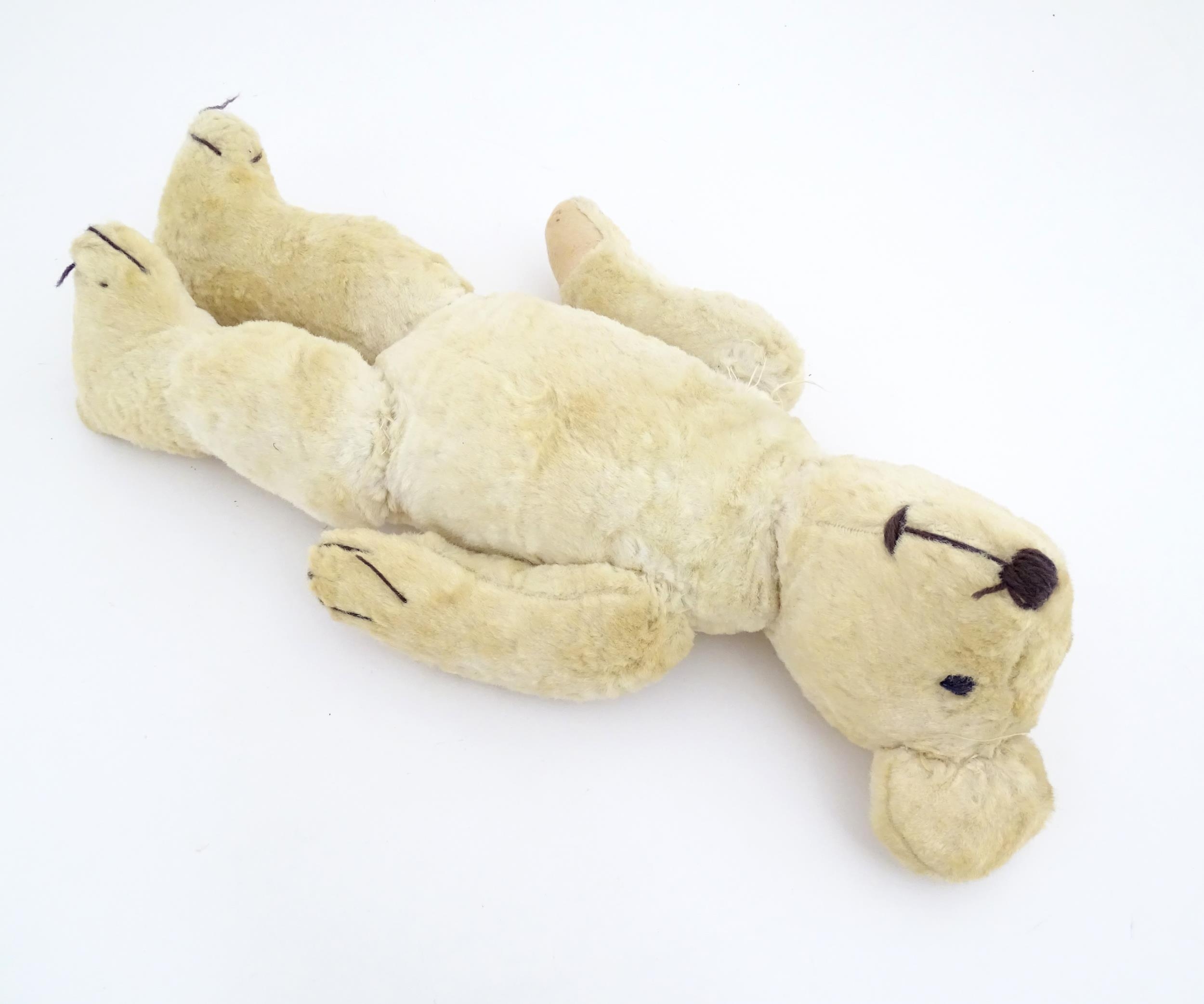 Toy: A 20thC plush teddy bear with stitched nose, mouth, eyes and paws. Approx. 19 1/2" long - Bild 4 aus 8