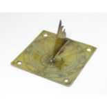 A brass sundial, the brass gnomon above a square base plate with engraved Roman numerals. 4 1/4" x 4