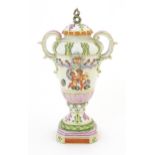 A Capodimonte twin handled vase and cover with hand painted cherub / putti, mask and foliate