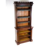 An early / mid 19thC mahogany bookcase with a moulded pediment above cluster columns flanking