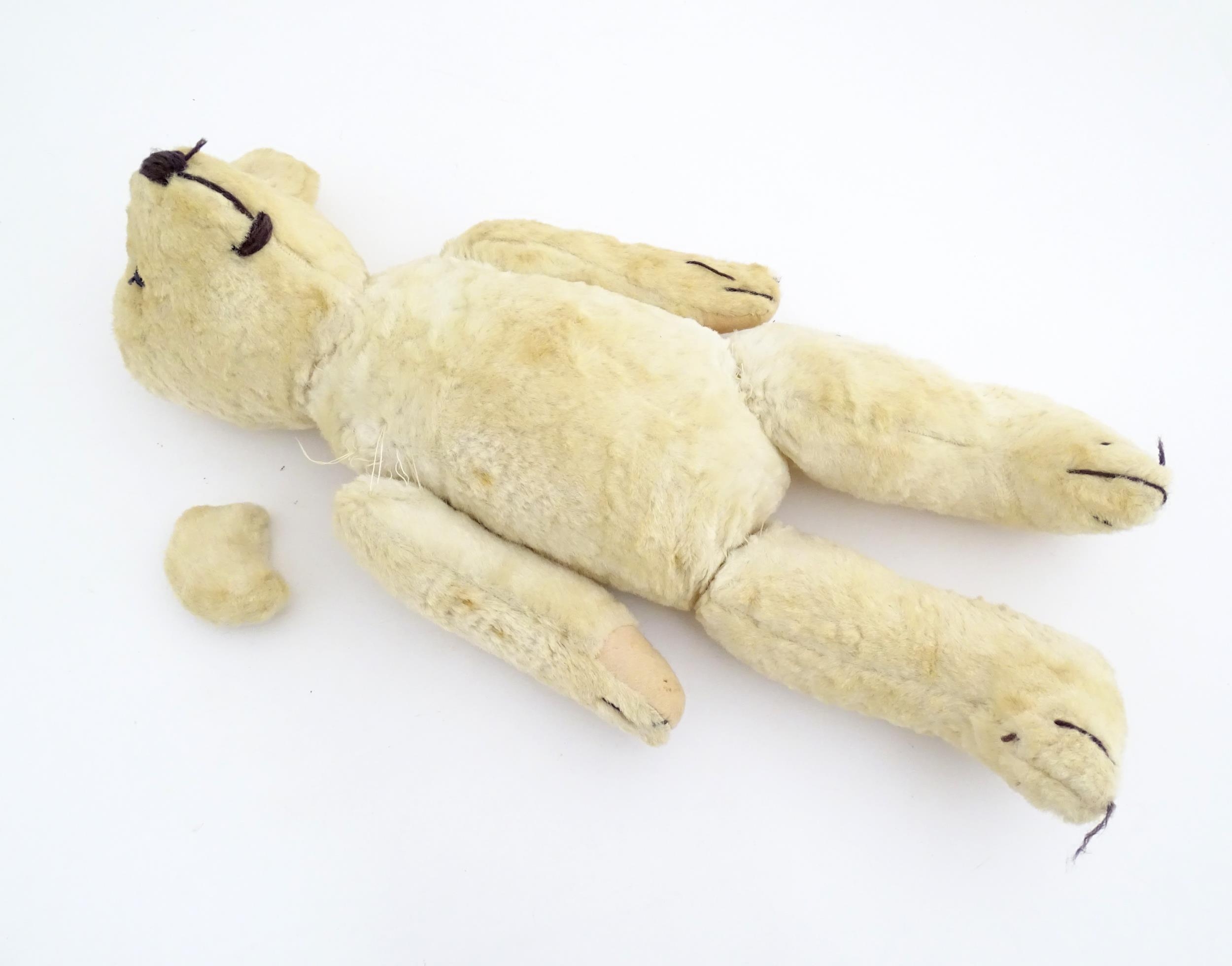 Toy: A 20thC plush teddy bear with stitched nose, mouth, eyes and paws. Approx. 19 1/2" long - Bild 6 aus 8