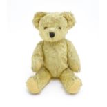 Toy: A 20thC straw filled teddy bear with stitched nose, mouth, and claws, pad paws and