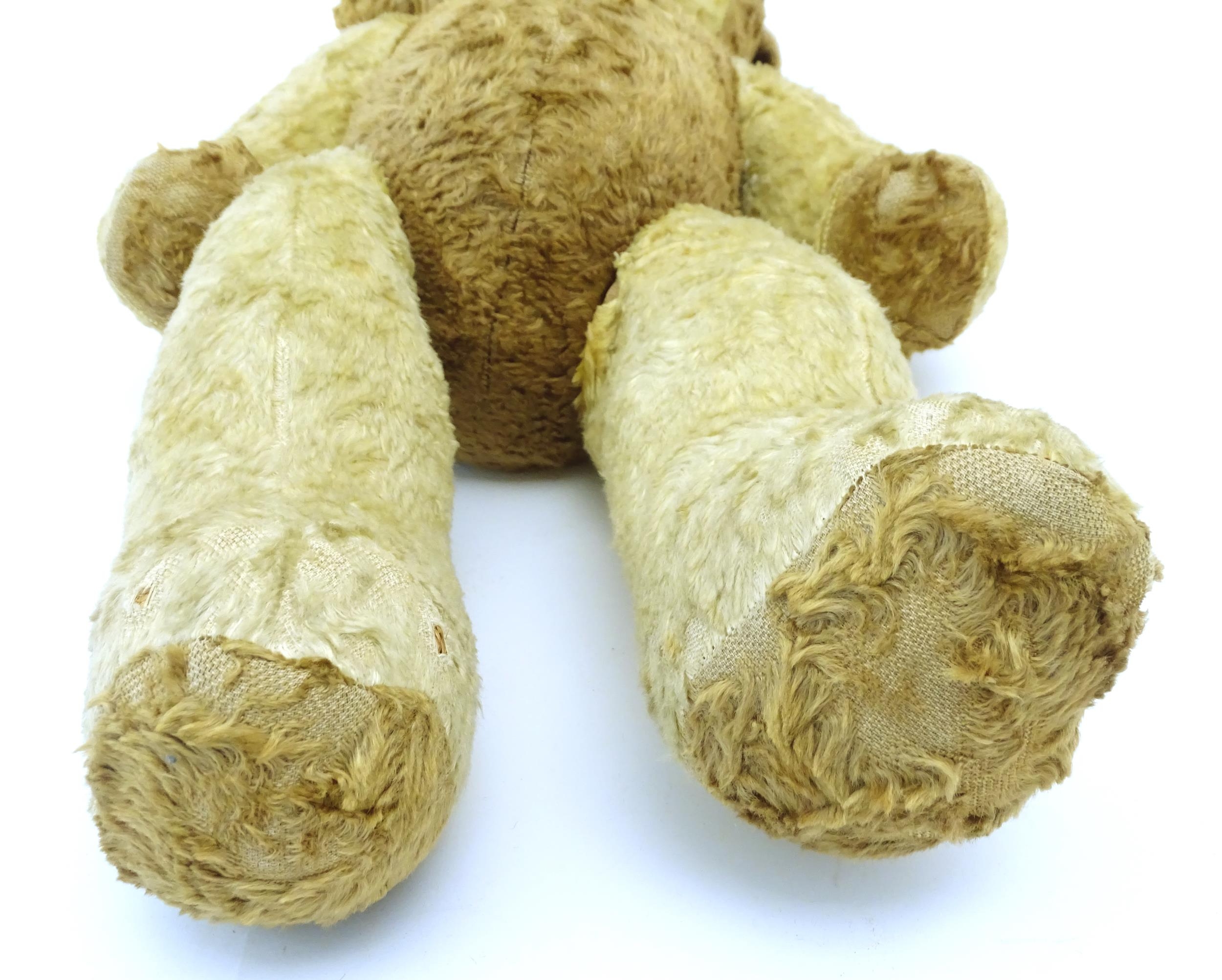 Toy: A 20thC straw filled teddy bear with leather tongue and articulated limbs. Approx. 22 1/2" - Bild 4 aus 7