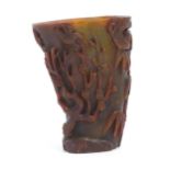 An Oriental carved horn libation cup decorated with birds, bamboo, flowering trees, etc. Approx.