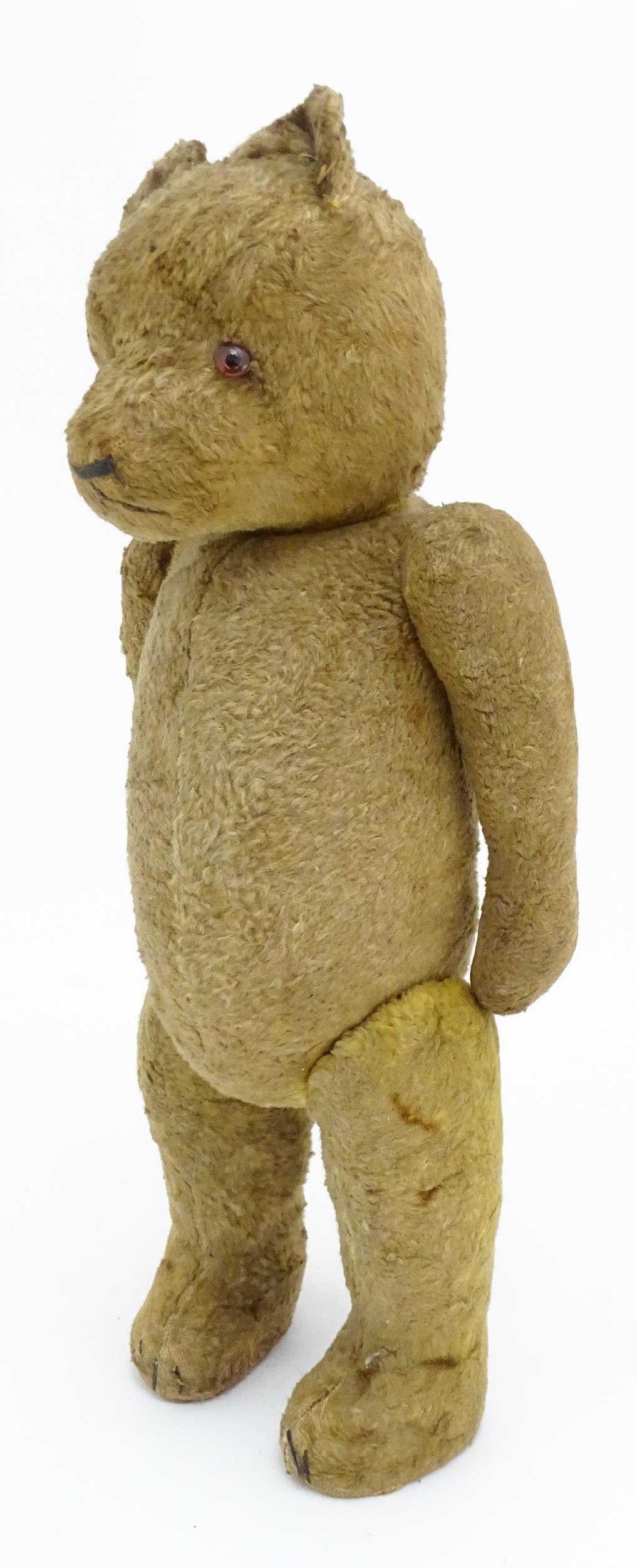 Toy: An early 20thC straw filled teddy bear with stitched nose, mouth and claws, glass eyes, pad - Bild 3 aus 8