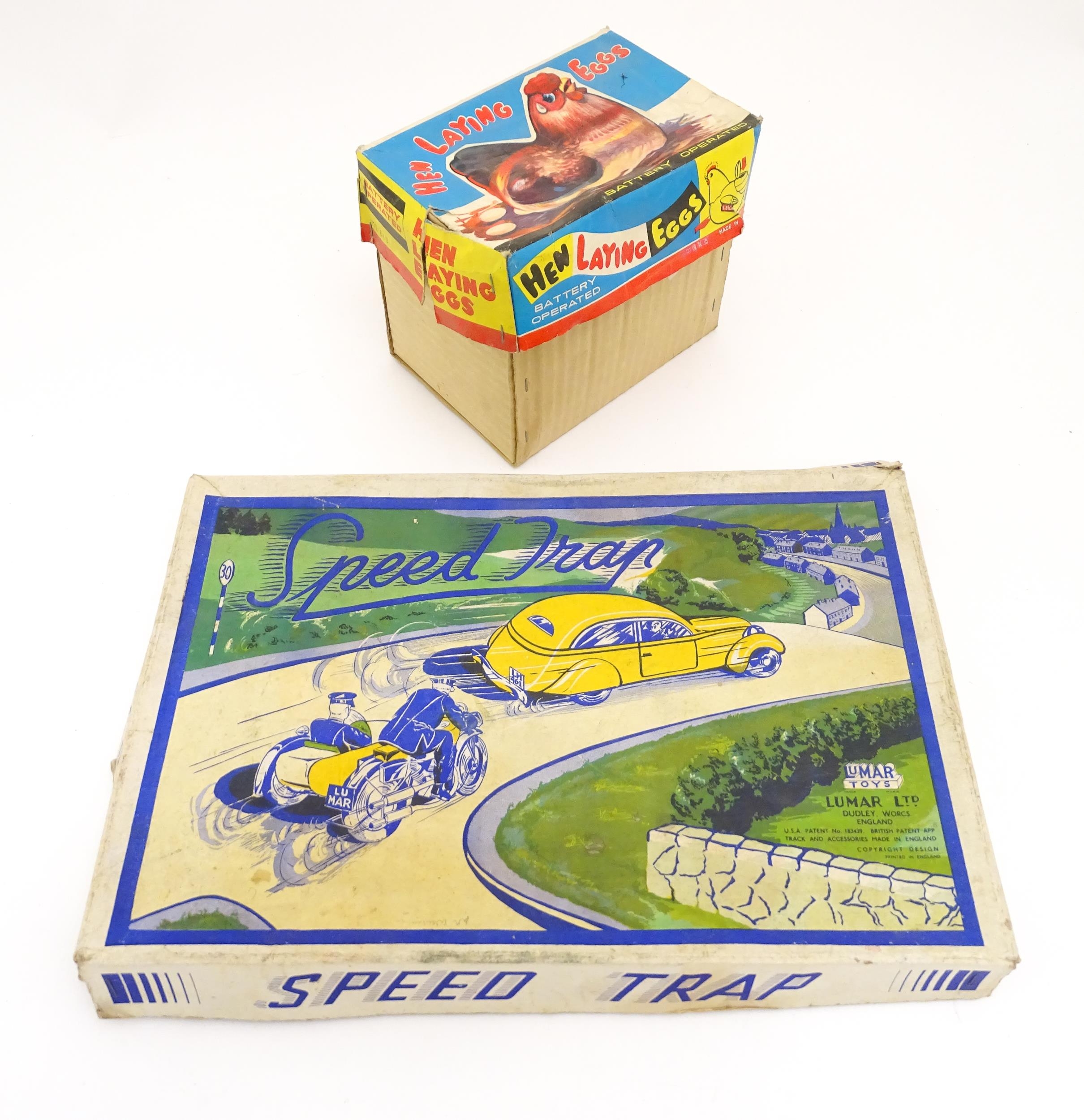 Toys: An early 20thC Lumar Toys tinplate Speed Trap clockwork game. Together with a Hen Laying