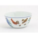 A Chinese famille rose tea bowl decorated with cockerel / rooster, hen / chicken and chicks, flowers