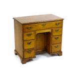 A George II pine knee hole desk, with a rectangular top above one long over one short drawer and two
