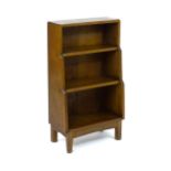 An Arts & Crafts, Cotswold School, oak waterfall style bookcase raised on four tapering legs. 20"