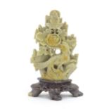 An Oriental soapstone carving depicting a bird, flower and foliage. Approx. 6" high Please Note - we