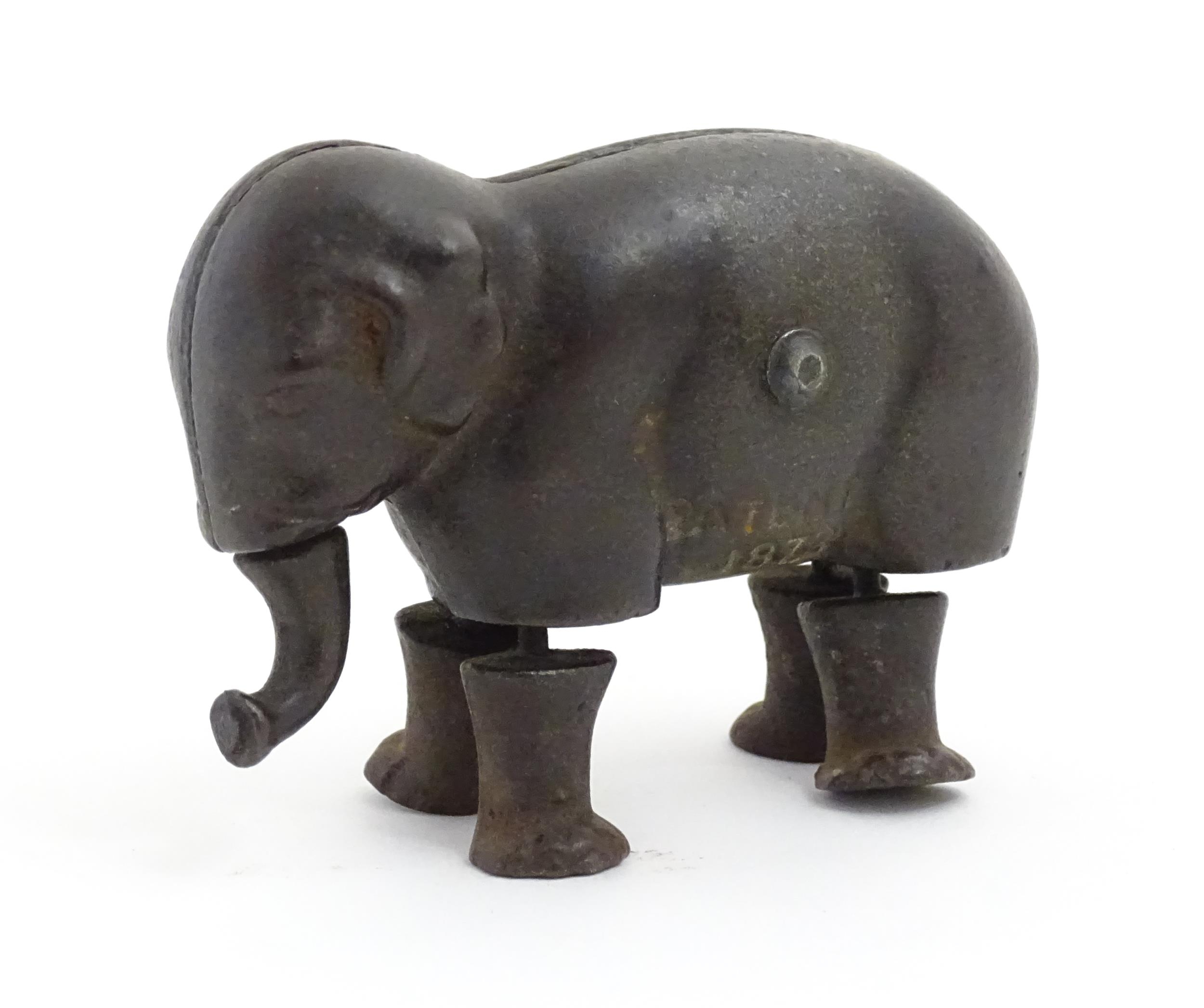Toy: A late 19thC cast iron walking elephant toy with articulated legs and trunk, by the Ives Toy