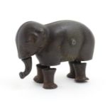 Toy: A late 19thC cast iron walking elephant toy with articulated legs and trunk, by the Ives Toy