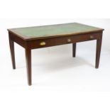 An early 20thC three drawer desk with an inset writing section above three short drawers and