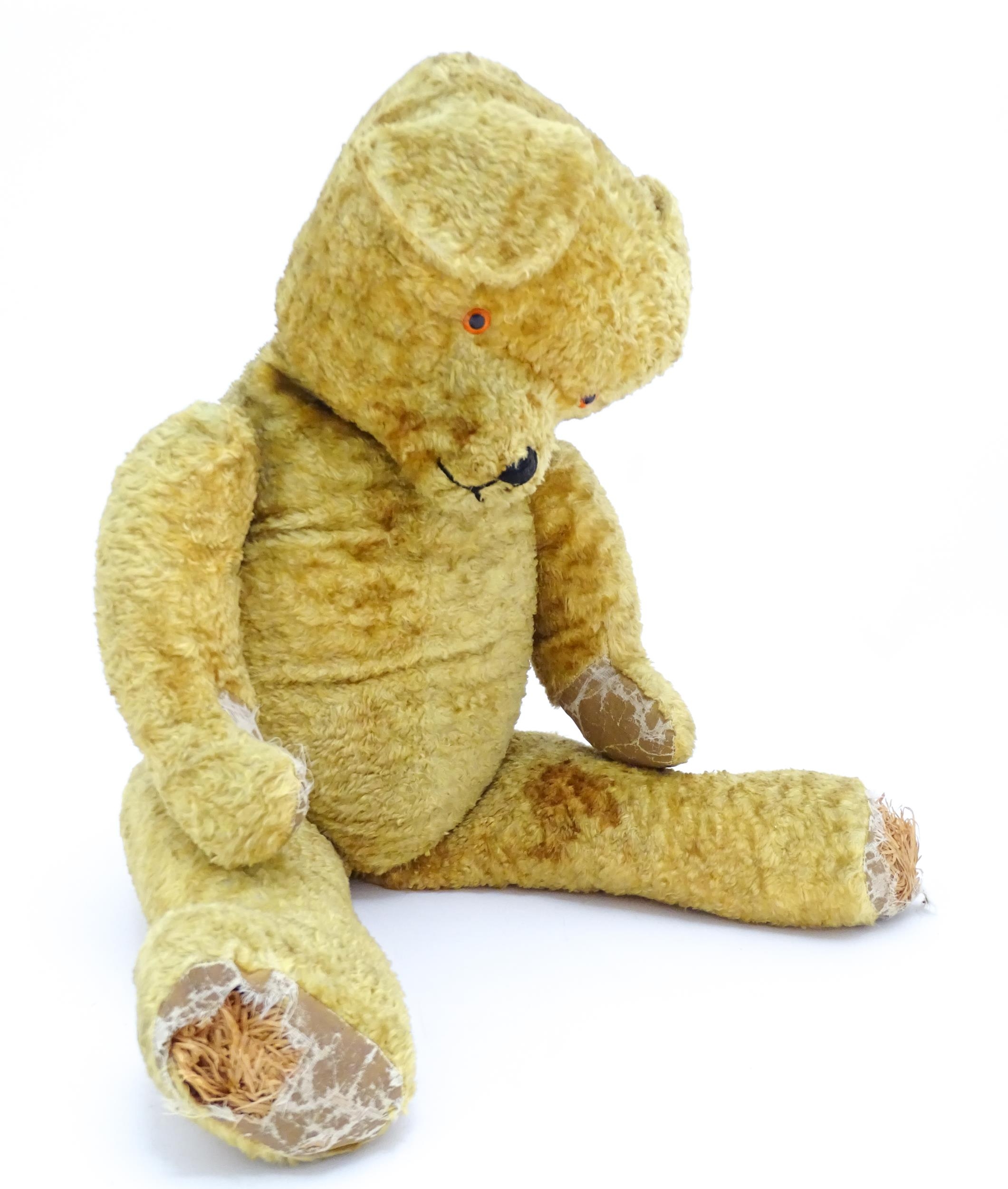 Toy: A large 20thC straw filled teddy bear with a stitched nose and mouth, and articulated limbs. - Bild 2 aus 8