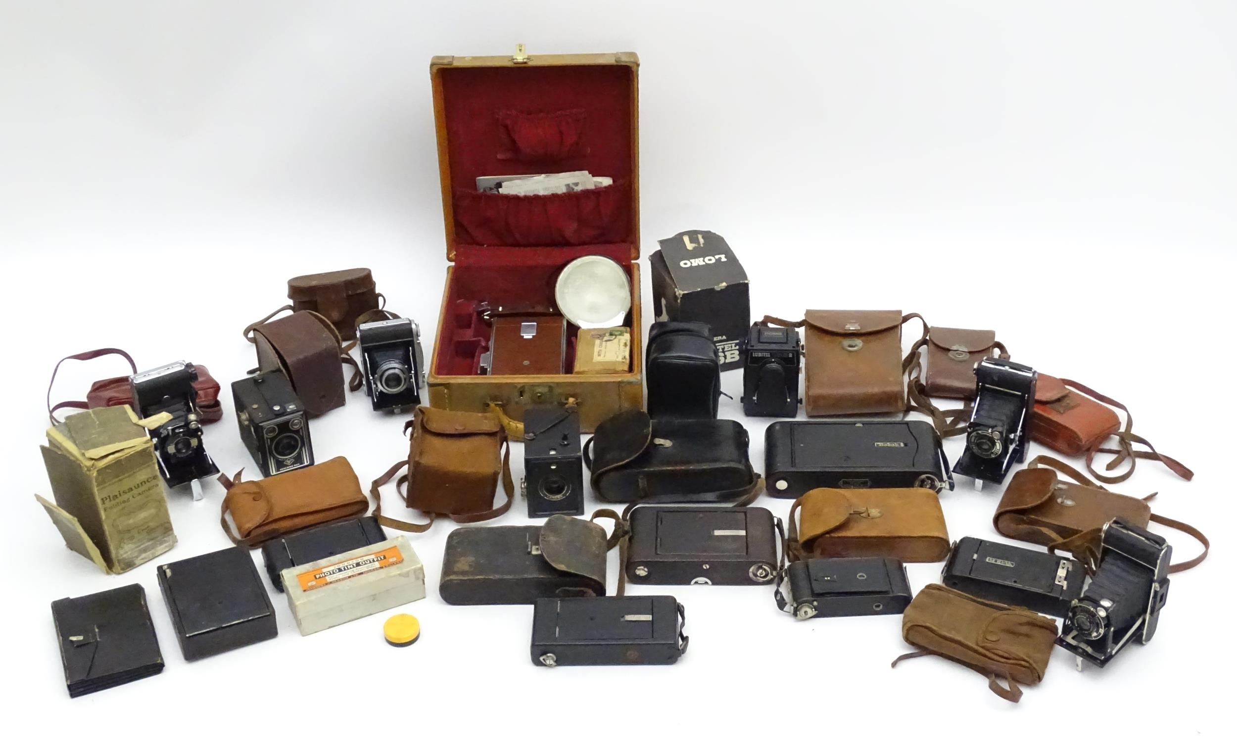 A quantity of 20thC cameras to include a Polaroid Land Camera model 95A with box and accessories,