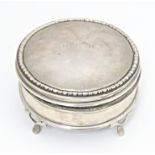 A silver ring box of circular firm with out swept feet, hallmarked London 1917, maker Charles