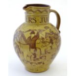 A terracotta hunting jug decorated with a hunting scene, 'Made by Harry Juniper of Bideford'.