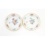 Two Dresden plates decorated with flowers and foliage with gilt rims. Marked under. Approx. 7 3/4"