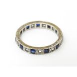 A 9ct gold eternity ring set with sapphires and white stones. Ring size approx. M 1/2 Please