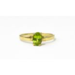 A 9ct gold ring set with central peridot. Ring size approx. L Please Note - we do not make reference