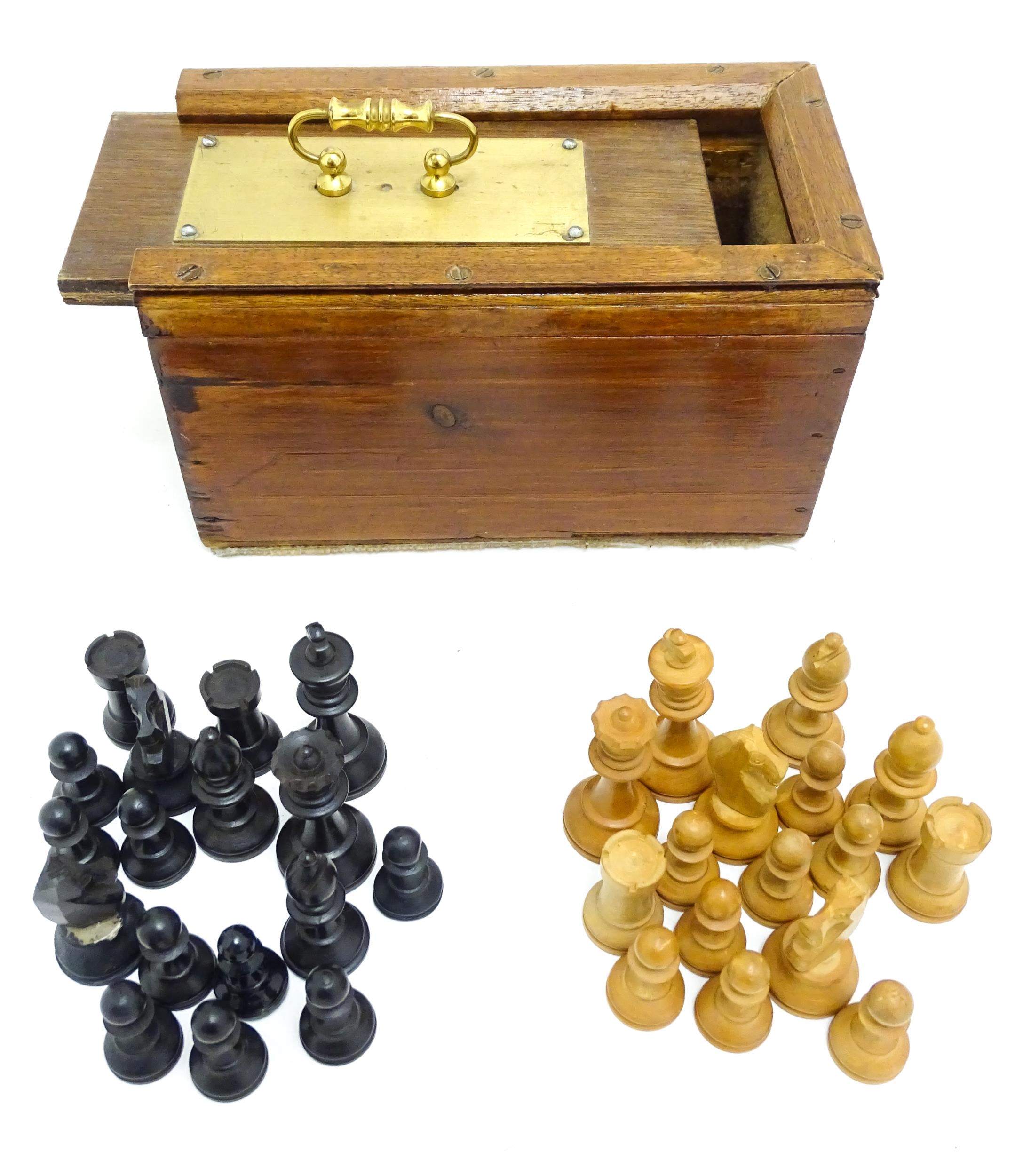 Toys: A quantity of chess pieces contained within a box with sliding lid and brass handle. (33