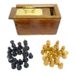 Toys: A quantity of chess pieces contained within a box with sliding lid and brass handle. (33