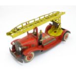 Toys: An early 20thC Mettoy tin plate clockwork fire engine with two firemen figures, a yellow