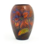 A Moorcroft pottery flambe vase of tapering ovoid form decorated in the Dahlia pattern. Impressed