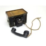 Militaria : a 20thC British Army field telephone, produced by General Electric, in black finish, the