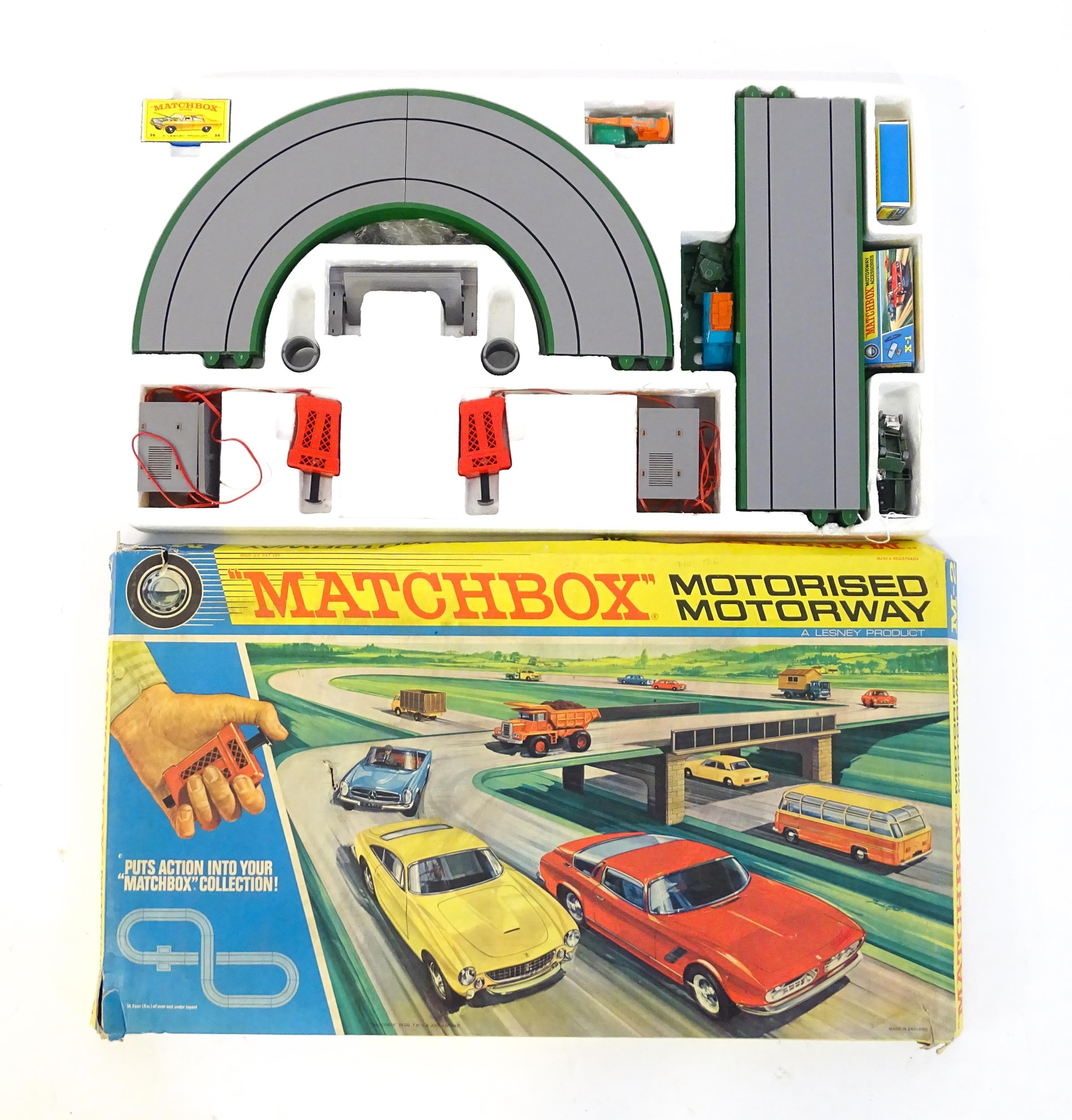 Toy: A boxed mid 20thC Lesney Matchbox M-2 Motorised Motorway set, containing boxed and loose