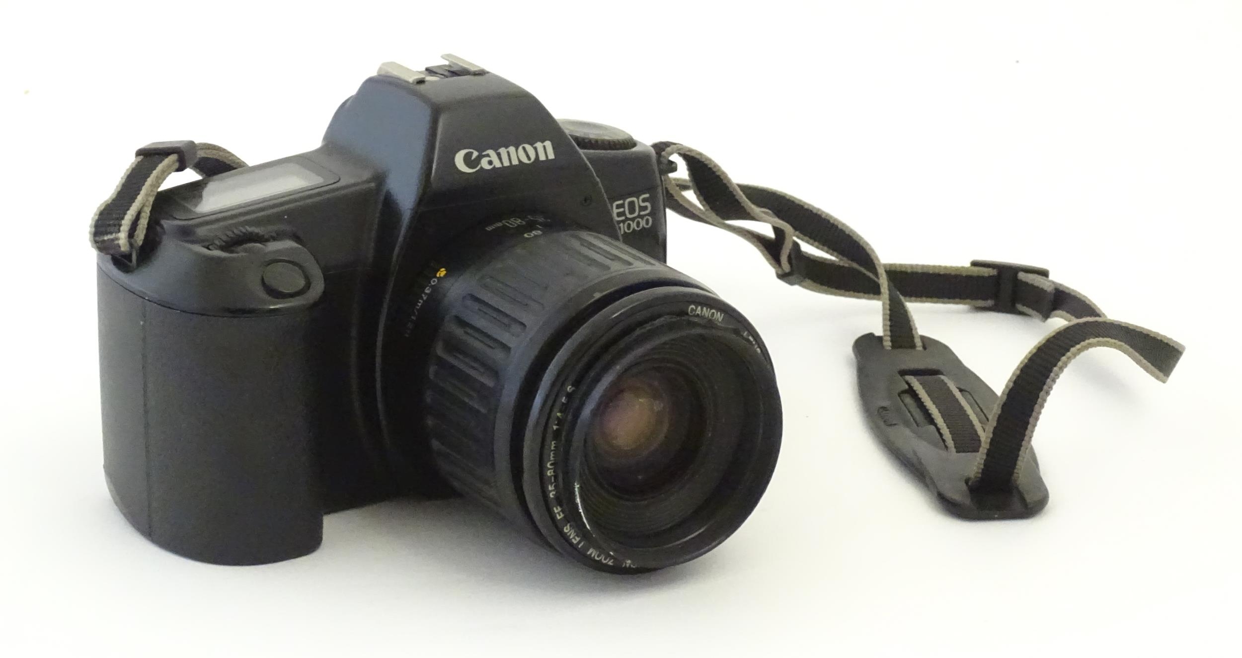 A Canon EOS 1000 camera with a 35-80mm f/4-5.6 lens. Please Note - we do not make reference to the