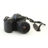 A Canon EOS 1000 camera with a 35-80mm f/4-5.6 lens. Please Note - we do not make reference to the