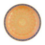 A Chinese plate with an orange ground and gilt decoration with a blue border. The reverse